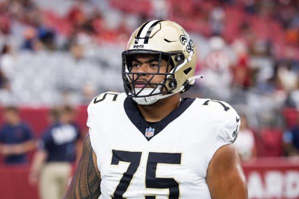 Saints OT Taliese Fuaga (back) misses practice