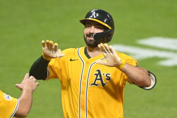 Athletics pour it on late to pull away from Guardians