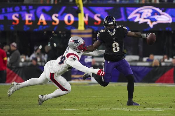 Ravens QB Lamar Jackson (back) departs against Patriots